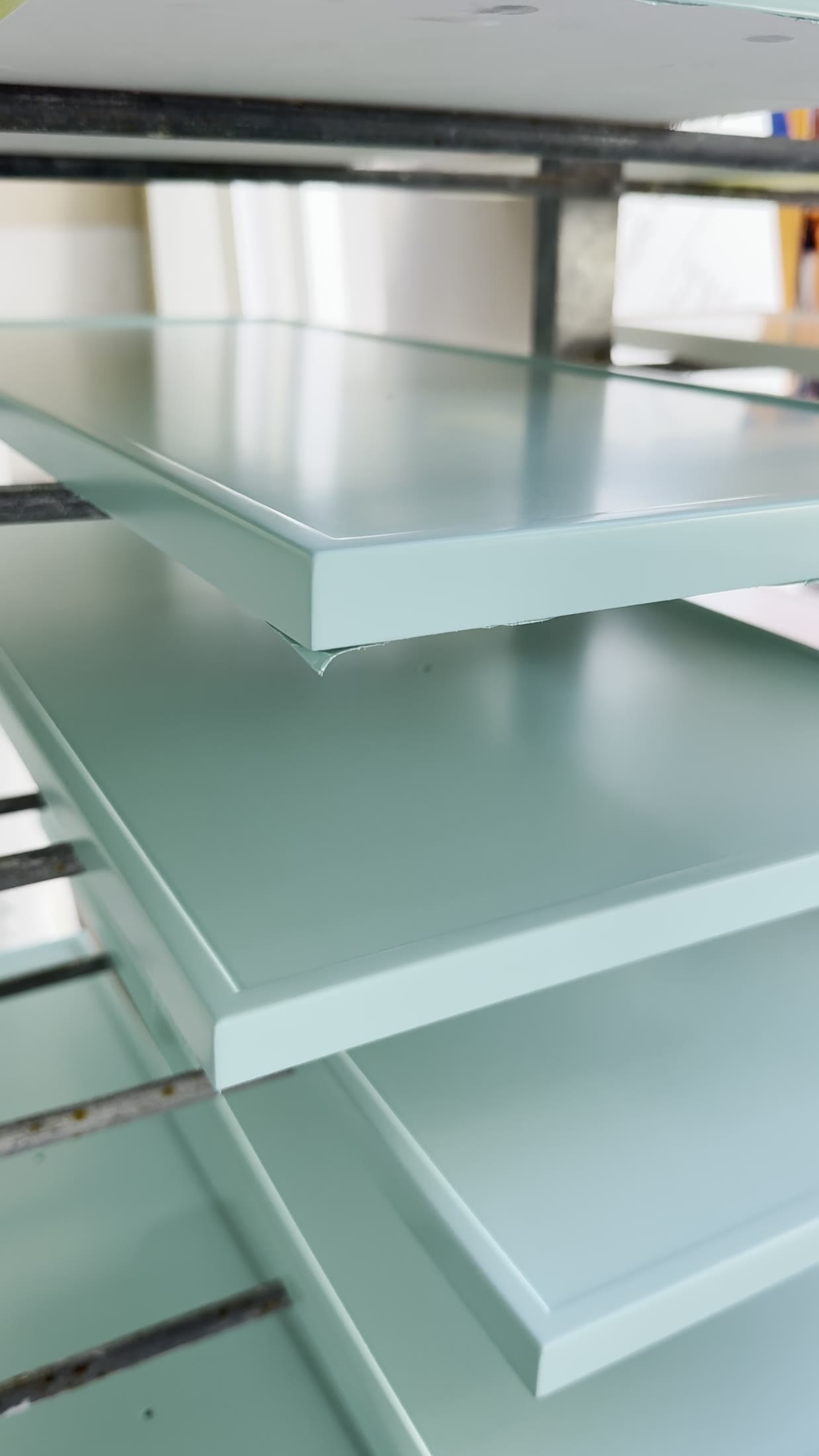 Sage green shaker doors on the spray rack, edges sealed and the finish even