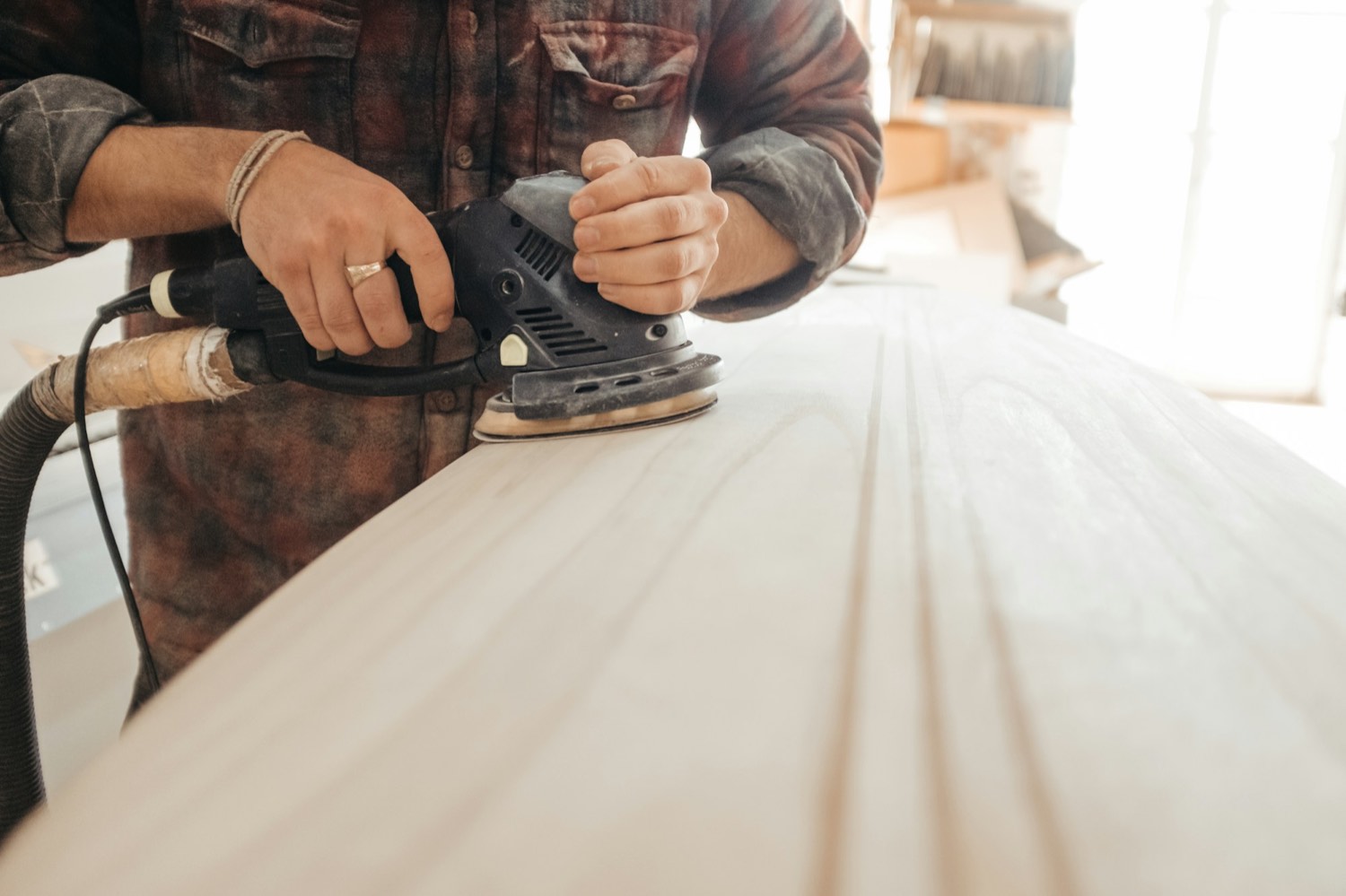 Sanding a timber surface back before finishing